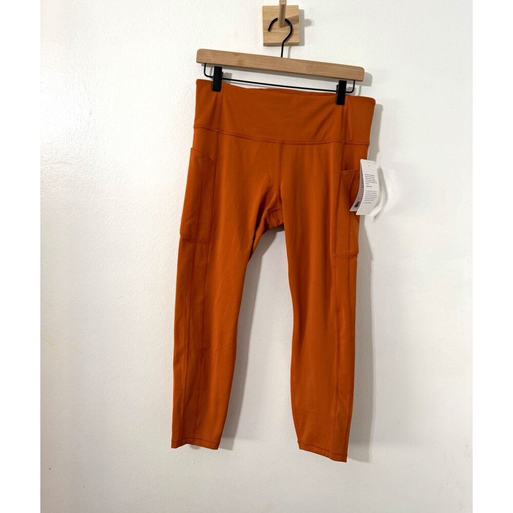 Athleta Ultimate Stash Women’s Leggings Sz L Orange Rust 7/8 Pocket Pull On
